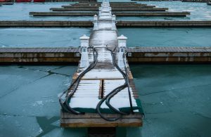 A dock in the process of being winterized - hoses are being installed for a deicing system