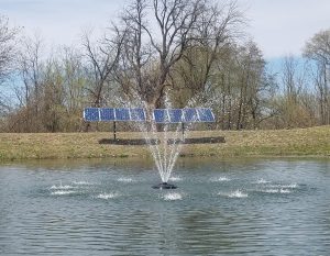 A solar powered fountain in a pond