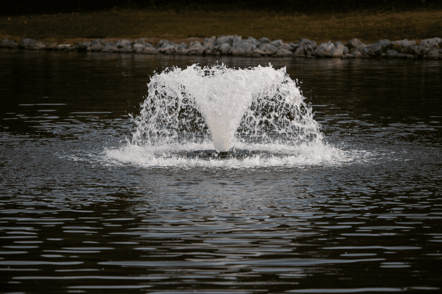 Up-close image of small fountain in pond