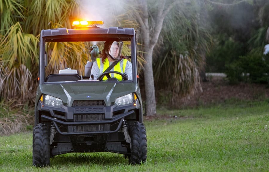 diluent abatement worker in an ATV spraying the area