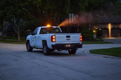 A Truck Spraying Adult Mosquitoes With An ULV Sprayer