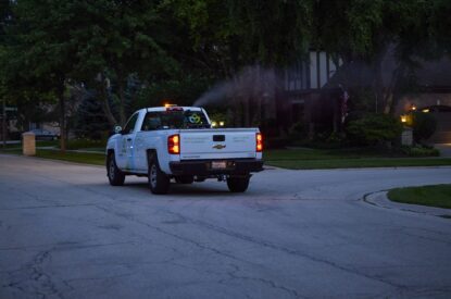 A Truck Spraying Adult Mosquitoes With An ULV Sprayer