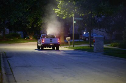 A Truck Spraying Adult Mosquitoes With An ULV Sprayer